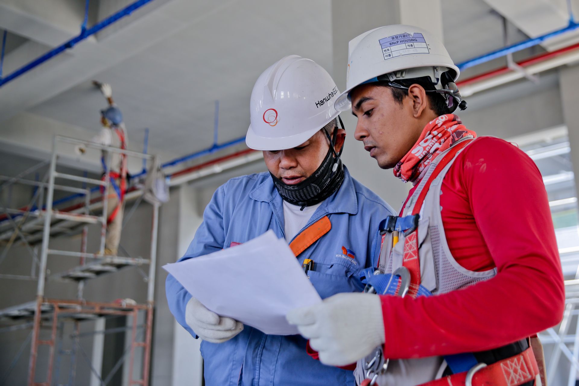 Construction crew in high-visibility PPE on an industrial site — stock visual, not Aqeeq staff