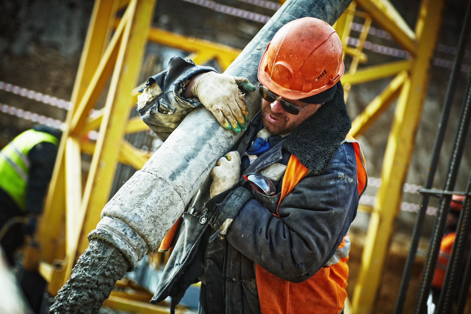 Worker in high-visibility PPE using industrial tools on site